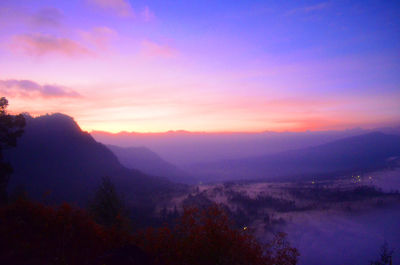 Scenic view of silhouette mountains against sky at sunset