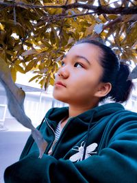 Portrait of beautiful young woman looking away