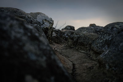 Low angle view of rock formation against sky