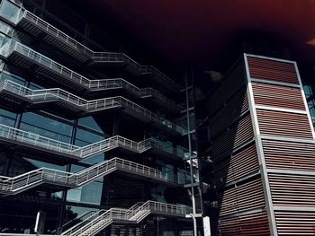 Low angle view of modern building against sky at night