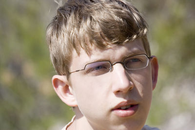 Close-up of thoughtful teenage boy looking away