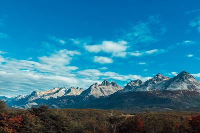 Scenic view of mountains against blue sky