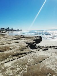 Scenic view of beach against clear blue sky