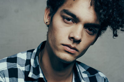 Portrait of young man against wall