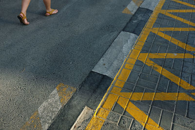Low section of people walking on road