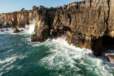 Waves splashing on rocks at shore