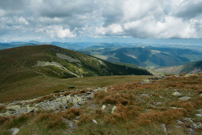 Scenic view of landscape and mountains against sky