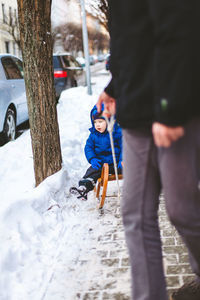 Rear view of people walking on snow