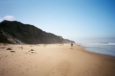 Scenic view of beach against clear sky