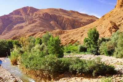 Scenic view of land and mountains against sky