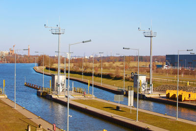 High angle view of railroad tracks by sea against clear sky