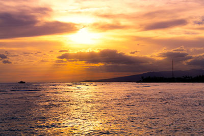 Scenic view of sea against orange sky