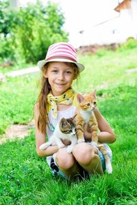 Portrait of smiling girl standing on field