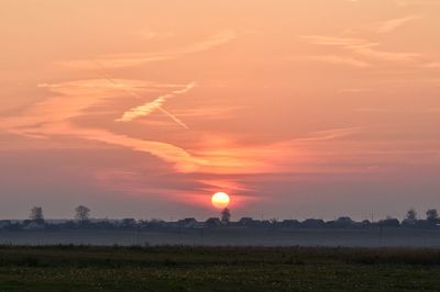 Scenic view of field against sky during sunset