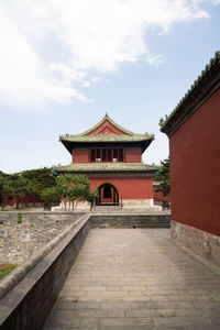 Temple by building against sky