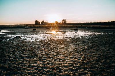 Scenic view of beach against sky during sunset