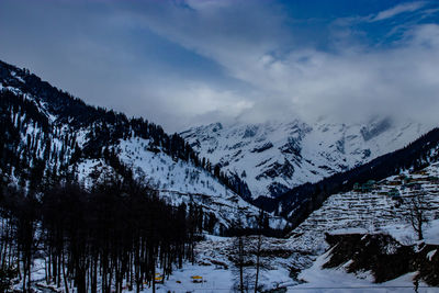 Scenic view of snowcapped mountains against clear blue sky