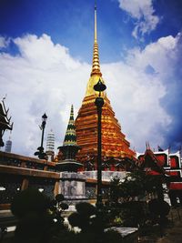 View of illuminated temple against cloudy sky