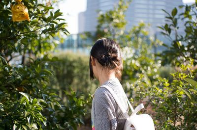 Woman standing on tree trunk