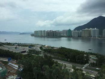 High angle view of bay and buildings against sky