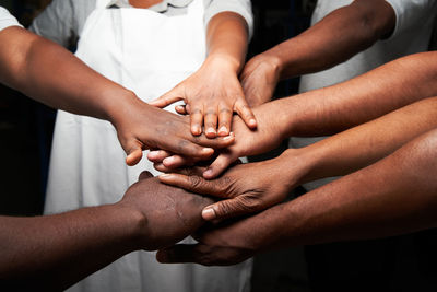 Midsection of couple holding hands