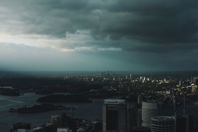 Aerial view of city against cloudy sky