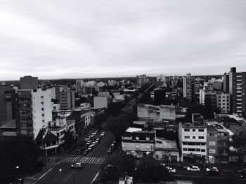 High angle view of cityscape against cloudy sky