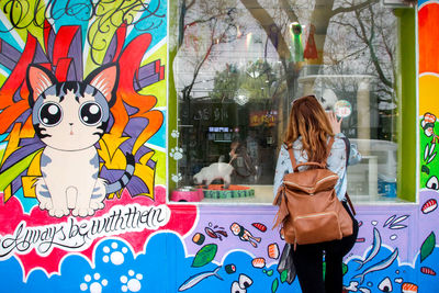 Woman with graffiti in store