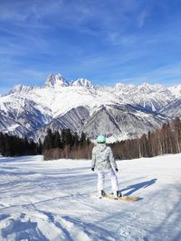 Man on snowcapped mountain against sky