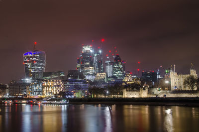 Illuminated city at waterfront