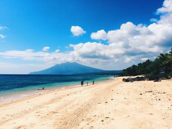 Scenic view of beach against blue sky