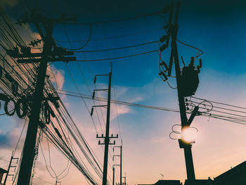 Low angle view of electricity pylon against sky