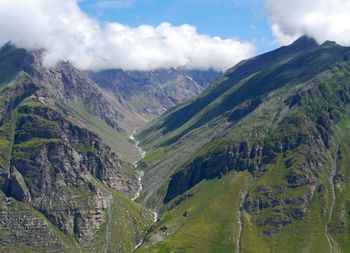 Scenic view of mountains against cloudy sky