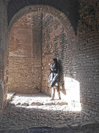 Woman standing in archway