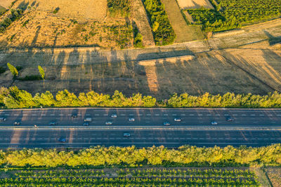Highway from a bird's eye view. as the sun goes down, the sun's rays create beautiful long shadows 