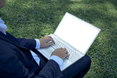 Midsection of man using mobile phone