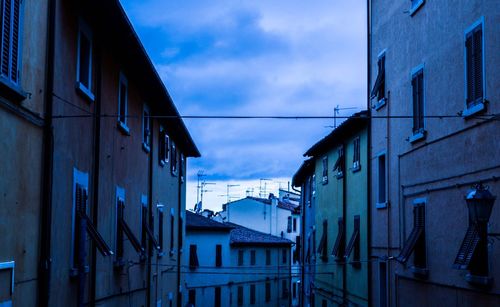 Low angle view of building against cloudy sky