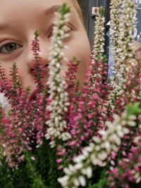 Close-up portrait of woman with pink flowers