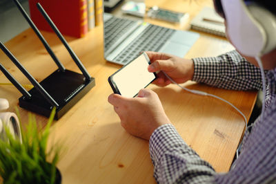 High angle view of man using laptop on table