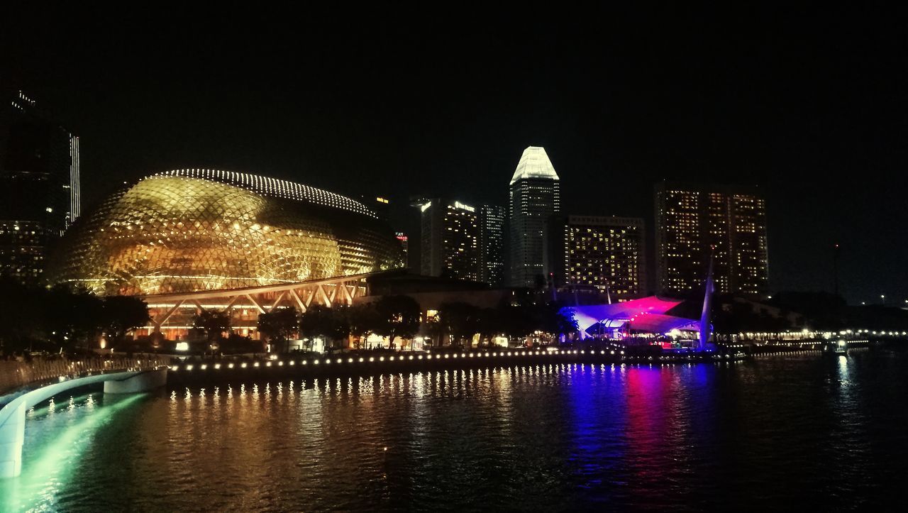 ILLUMINATED BUILDINGS AT WATERFRONT