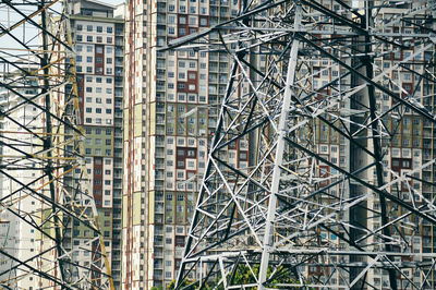 Full frame shot of electricity power lines close to an apartment buildings