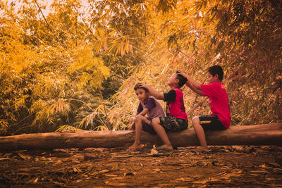 Women standing by tree during autumn