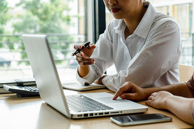 Midsection of woman working on table