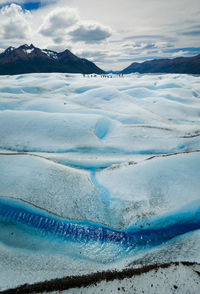 Scenic view of frozen sea against mountain range