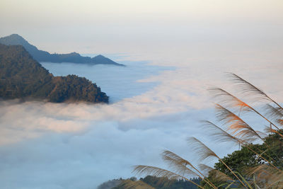 Scenic view of mountains during foggy weather against sky