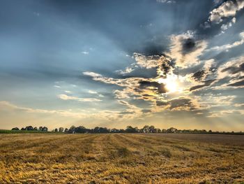 Scenic view of field against sky during sunset