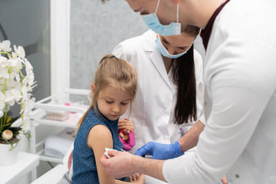 Side view of doctor examining patient at home