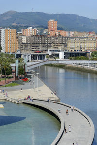 High angle view of buildings by river in city