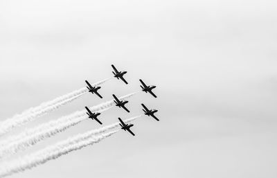 Low angle view of airplane flying against sky