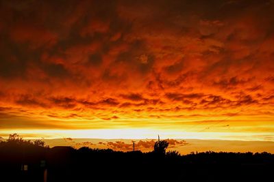 Silhouette of landscape against cloudy sky